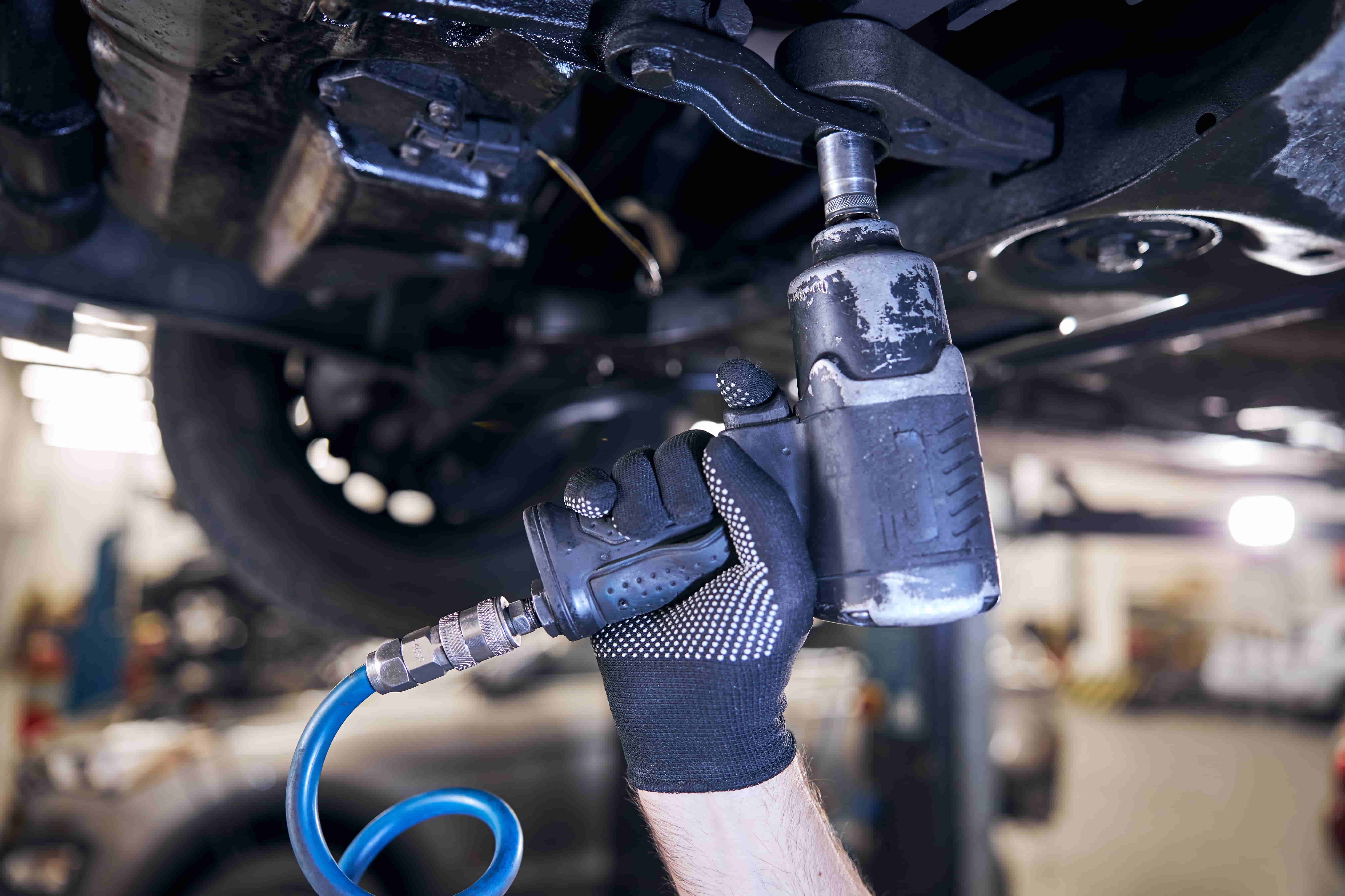 Car Servicing & Repairs in Fawkner Professional undercarriage repair in Fawkner - Expert mechanic using pneumatic tools for suspension and chassis servicing